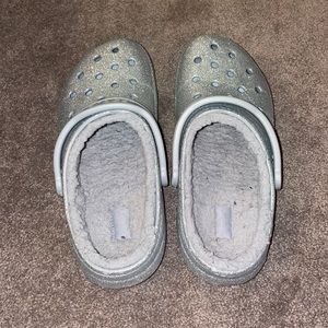 Silver glitter lined crocs.